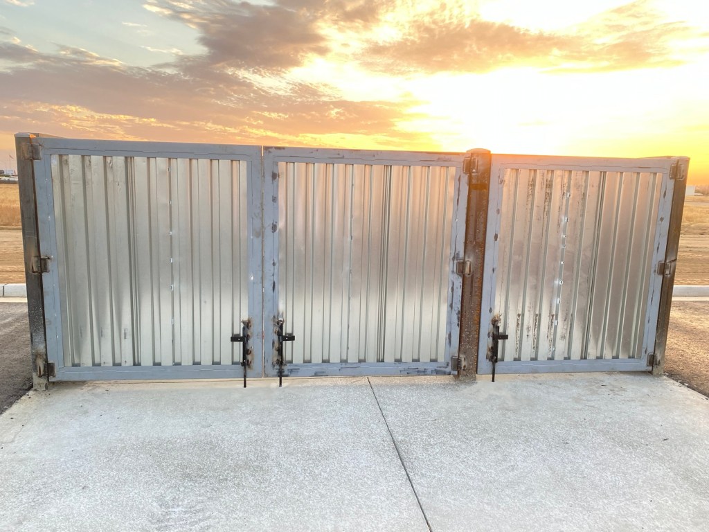 Installed metal gates at an industrial site at sunset