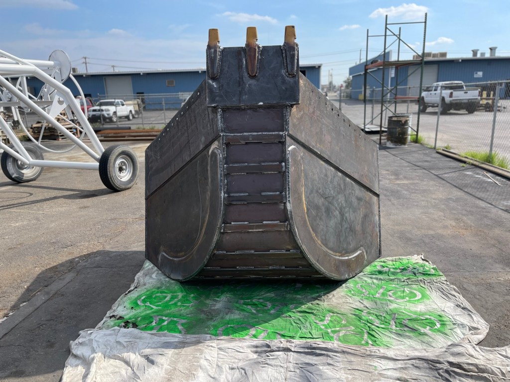 Rear view of heavy-duty excavator bucket with wear plate