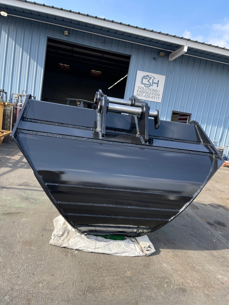 Excavator bucket with fabricated steel shell