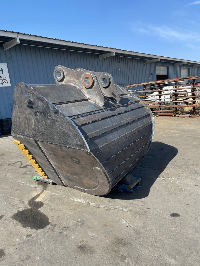Excavator bucket undergoing heavy equipment repair