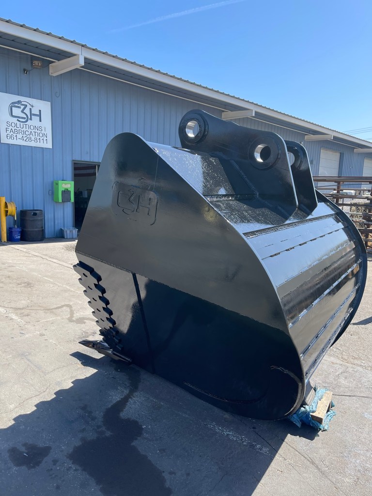 Finished excavator bucket with reinforced steel shell