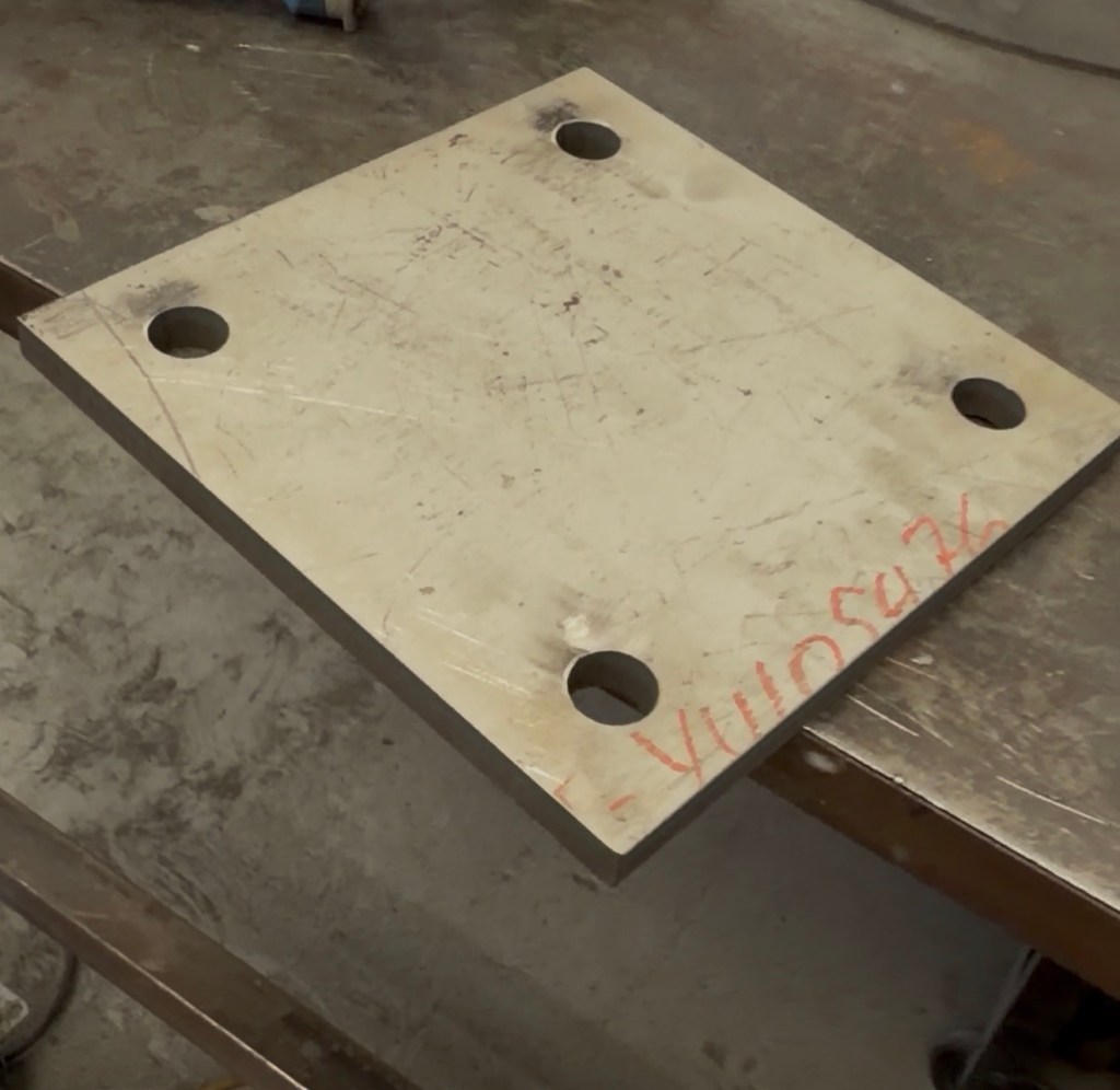 Laser-cut plate component with mounting holes