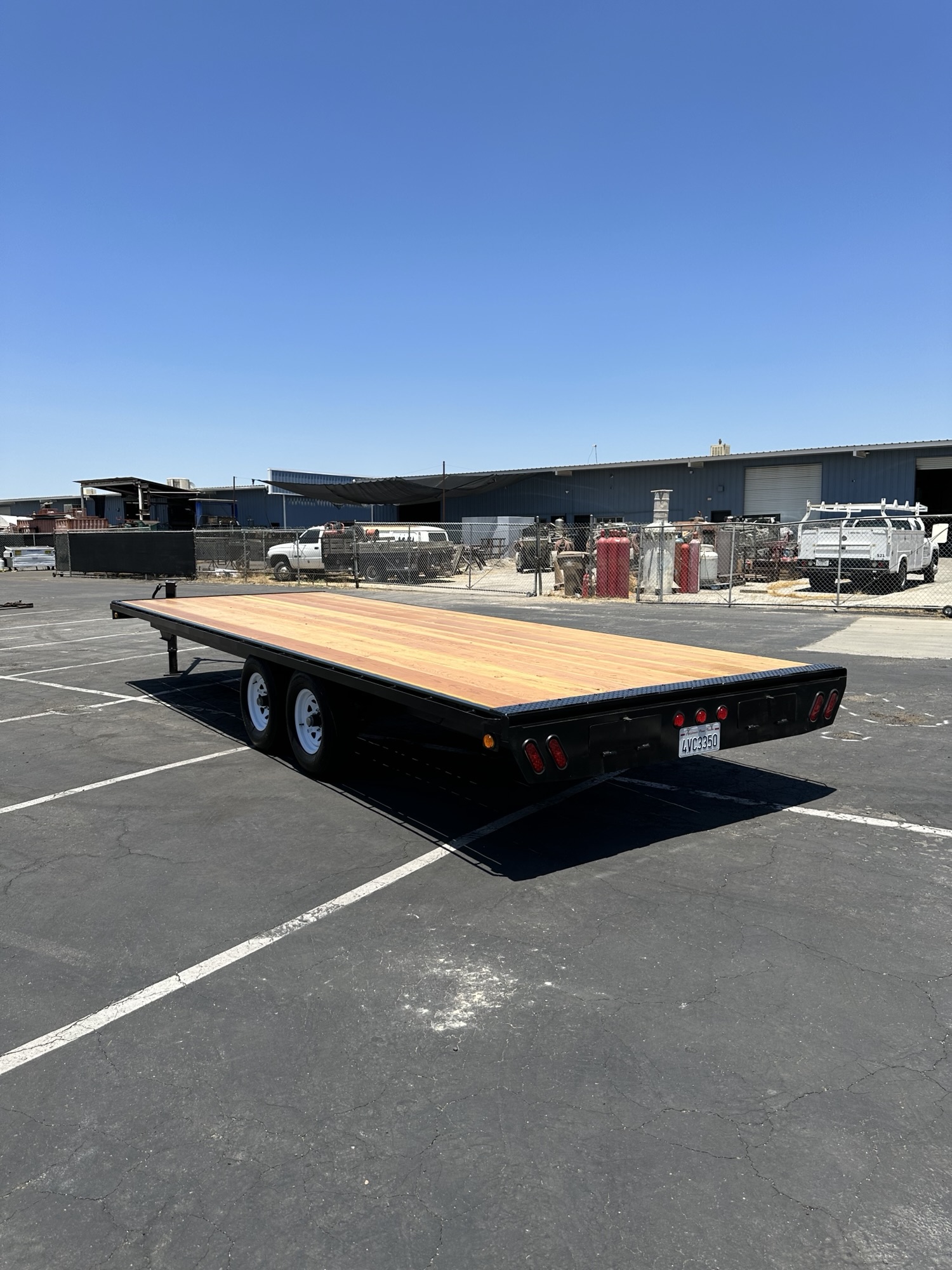 Custom flatbed trailer with wood deck and tandem axles