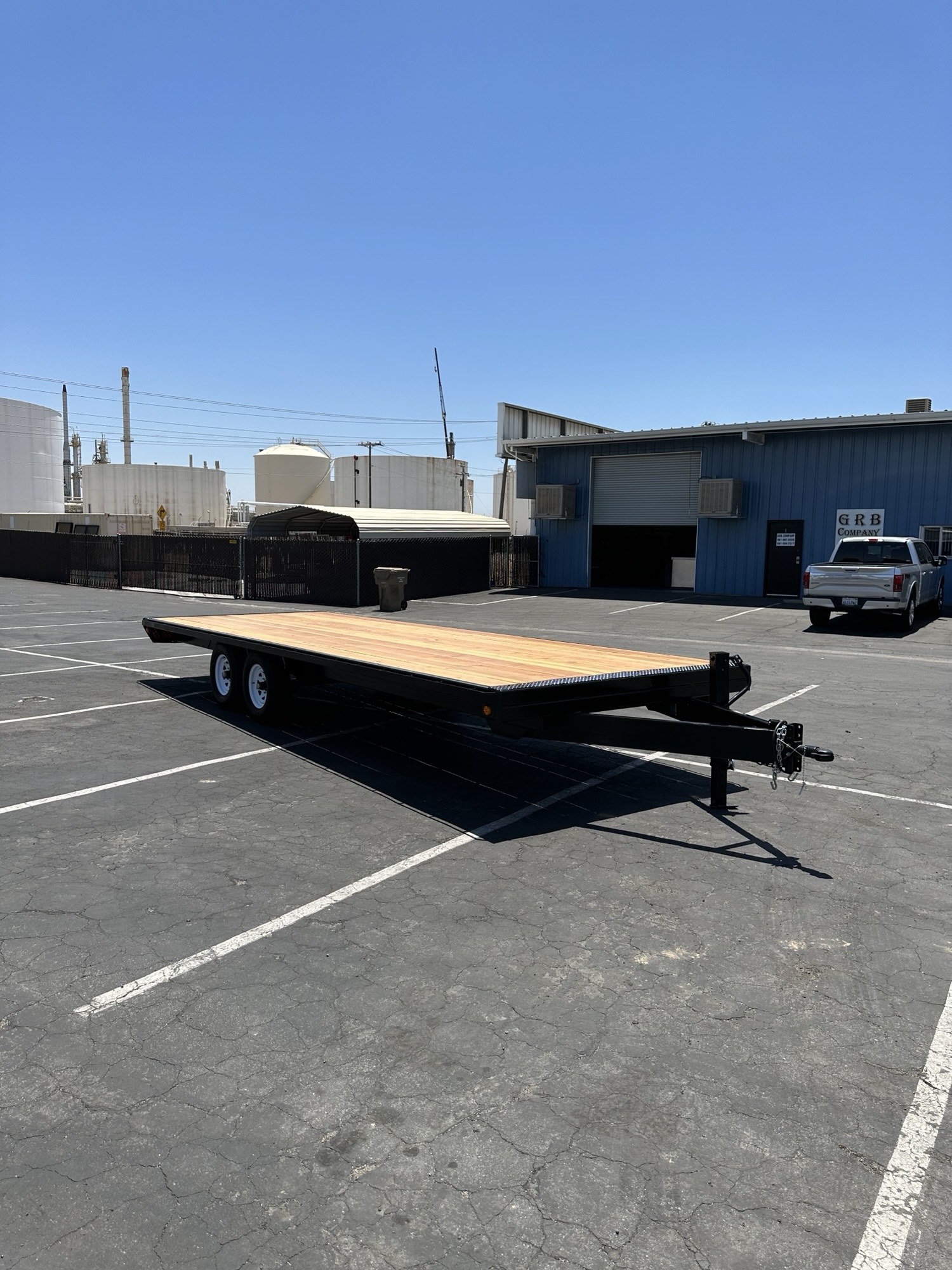 Side view of a custom flatbed trailer with wood deck