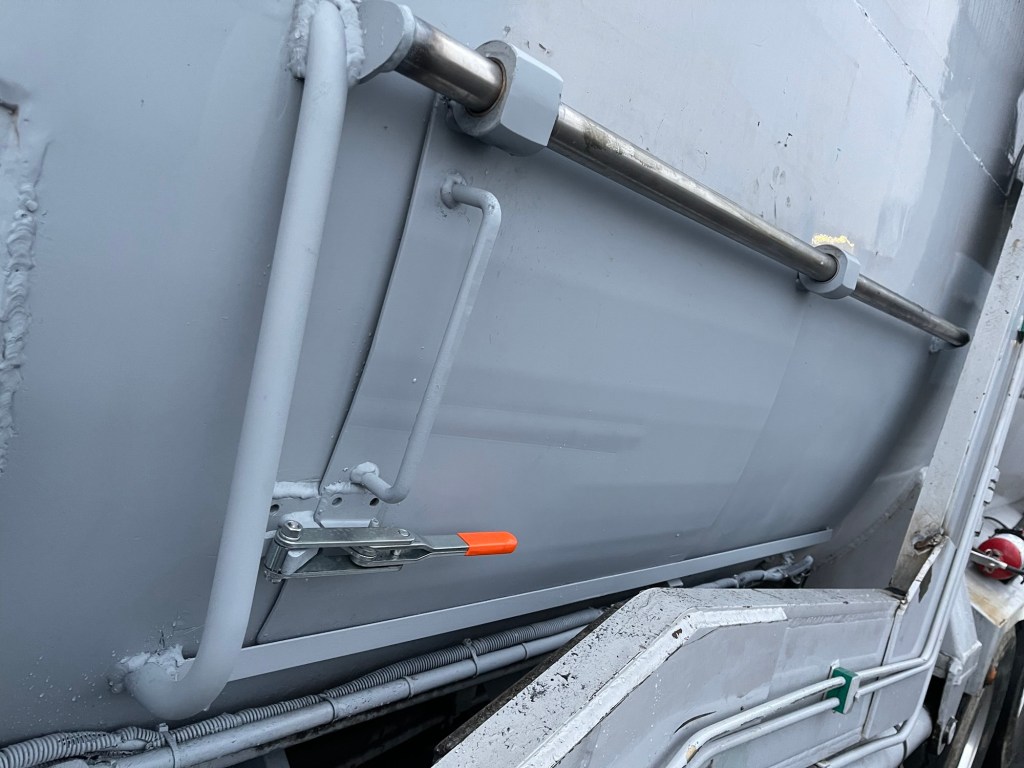 Rear panel of a sanitation truck body after metal repair