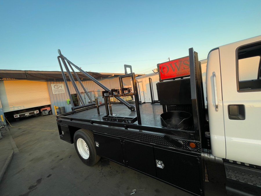 Finished work truck service body with fabricated rack