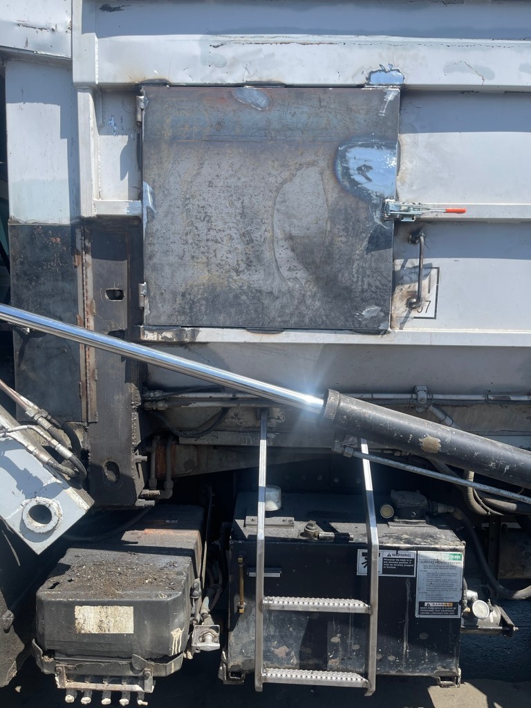 Sanitation truck body repair with steel components exposed during fabrication