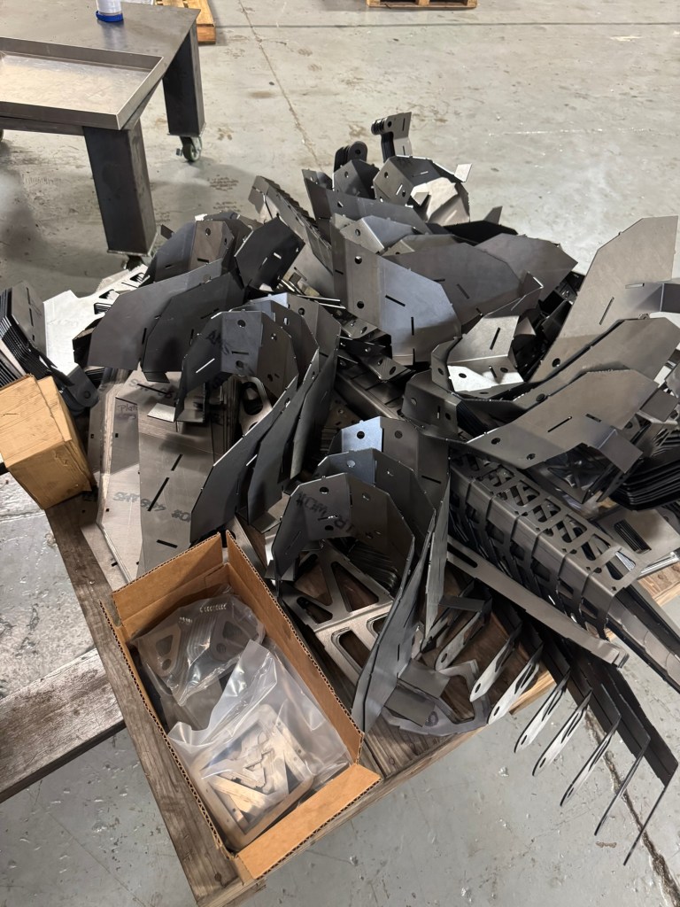 Batch of formed steel components after press brake work