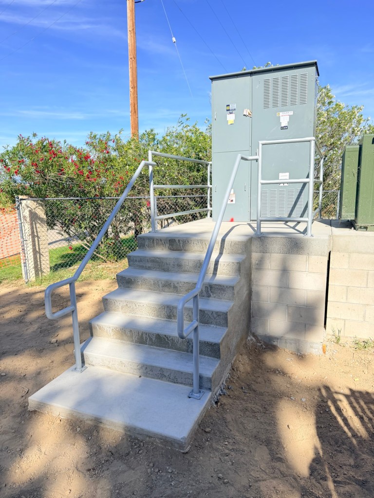 Fabricated steel handrails at an onsite utility equipment platform