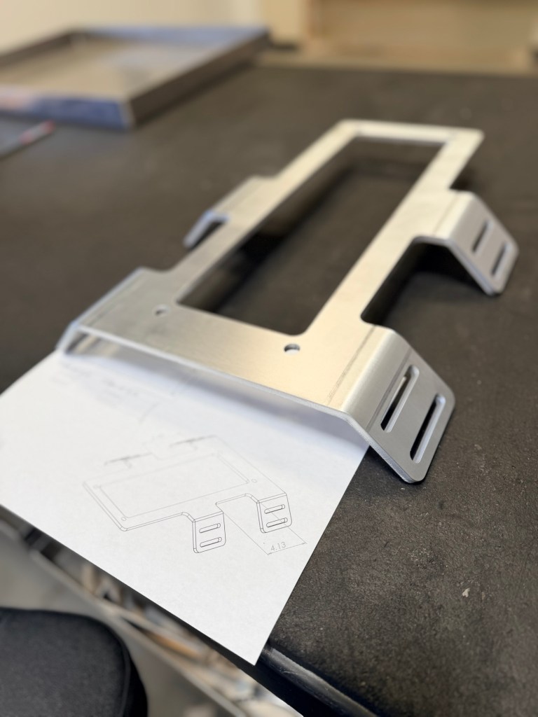 Custom formed metal bracket with mounting slots