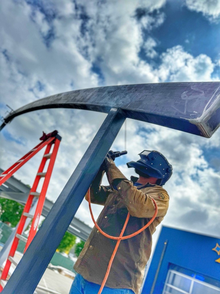 Certified welder working on structural steel in the field