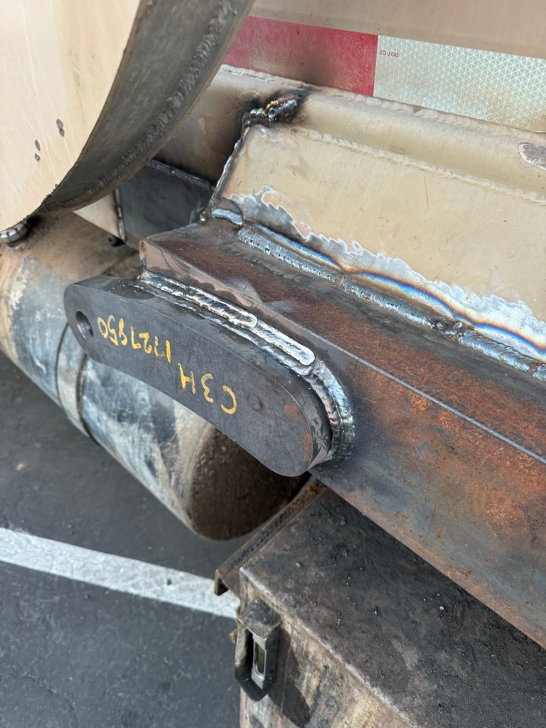Welded repair seam on sanitation truck body steel